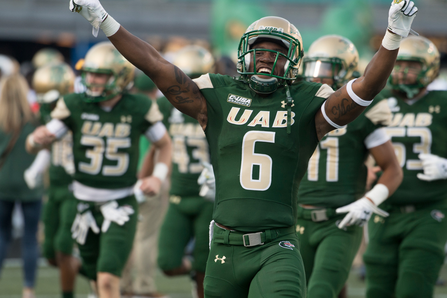 UAB football player celebrates on the field.
