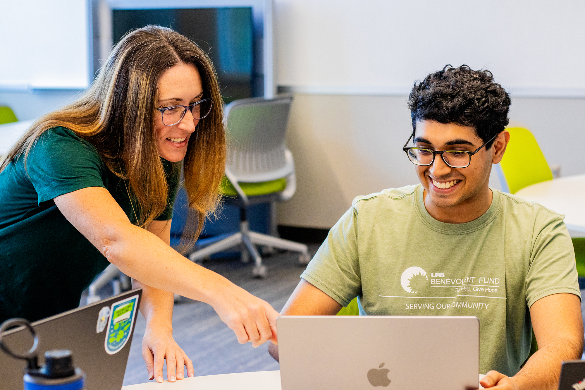 Amber Wagner, Ph.D. assists a student in a class setting.