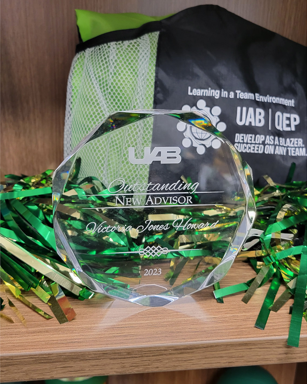 Victoria Jones Howard's UAB Outstanding New Advisor Award displayed on her office shelf.