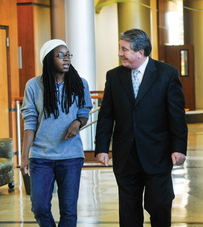 Dean Palazzo walking with a student. 