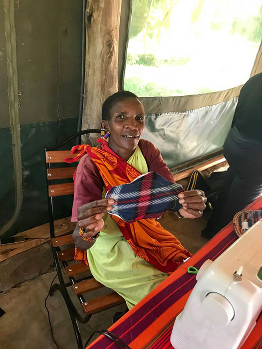 A Maasai woman sewing a sanitary napkin.