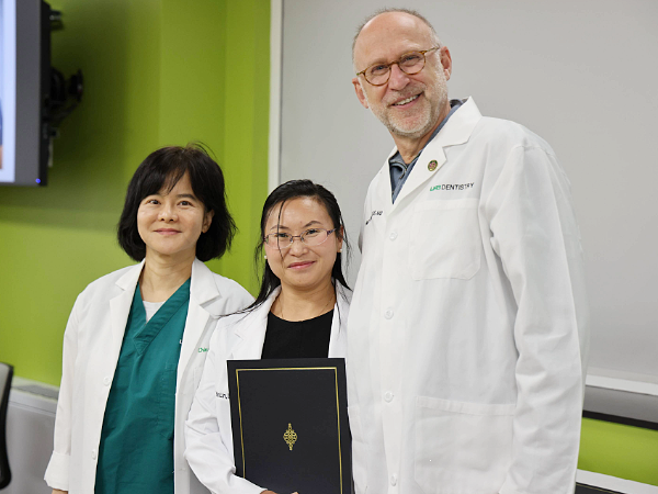 Lin (center) with Dr. Fu (left) and Dean Geurs (right).