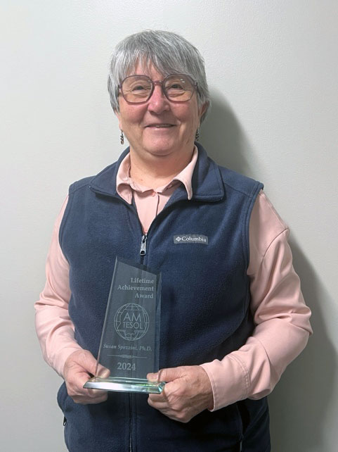 Spezzini holding her award. 