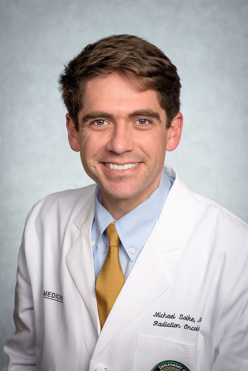 Headshot of Dr. Michael "Mike" Soike, MD (Assistant Professor, Radiation Oncology) in white medical coat, September 2023.