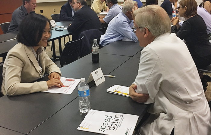 Dr. William Holman and Dr. Margaret Liu discuss their clinical and research interests at last year's collaborative Speed Dating event.