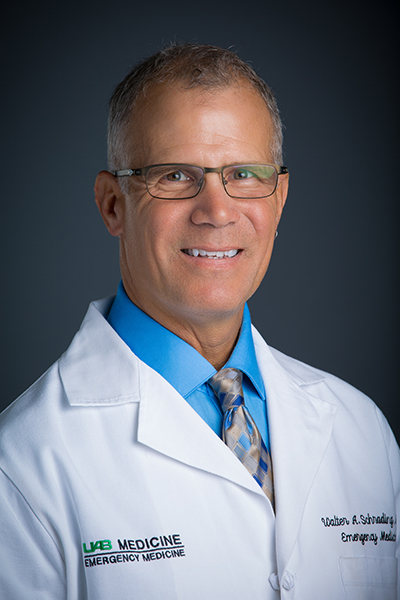 Headshot of Dr. Walter Schrading, MD (Associate Professor, Emergency Medicine) in white medical coat, 2016.