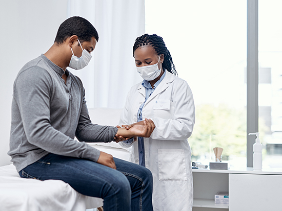 Doctor checking a patient's pulse