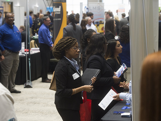 Students look at posters at a recruiting fair at UAB