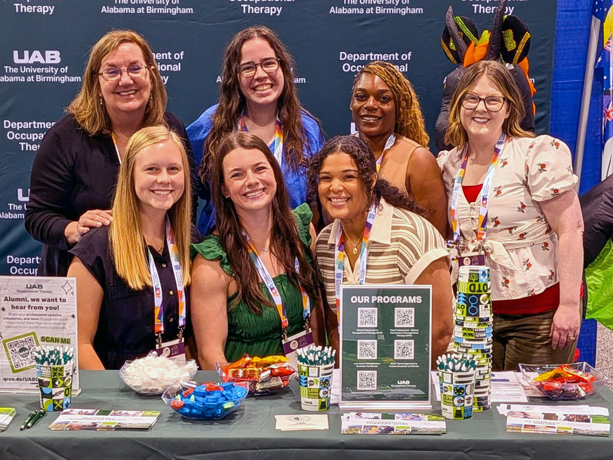 Students and faculty at the OT booth at AOTA Inspire.