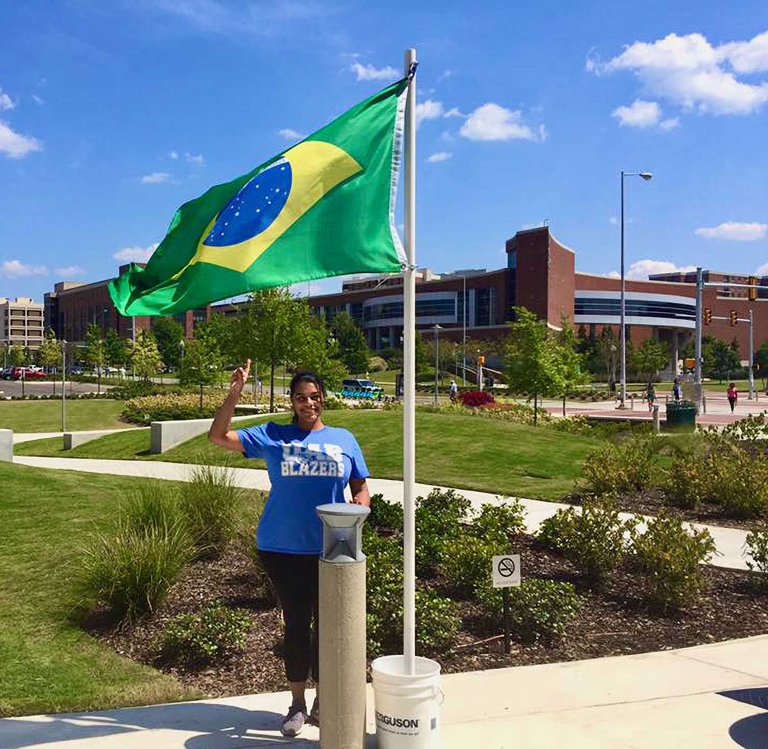  Dr. dos Anjos under the Brazilian flag flying on UAB's campus.