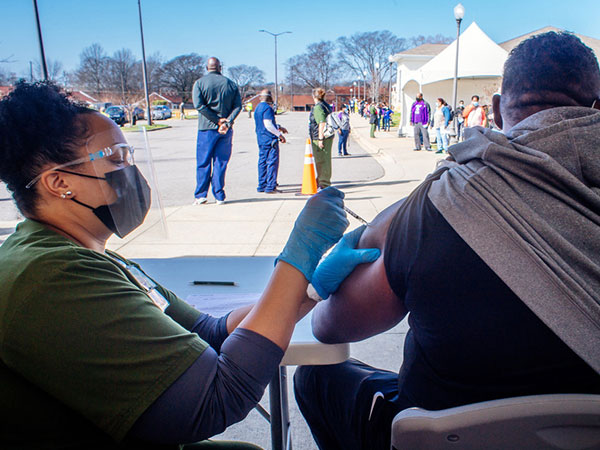 Man getting vaccinated at the UAB-Parker High School vaccine clinic.