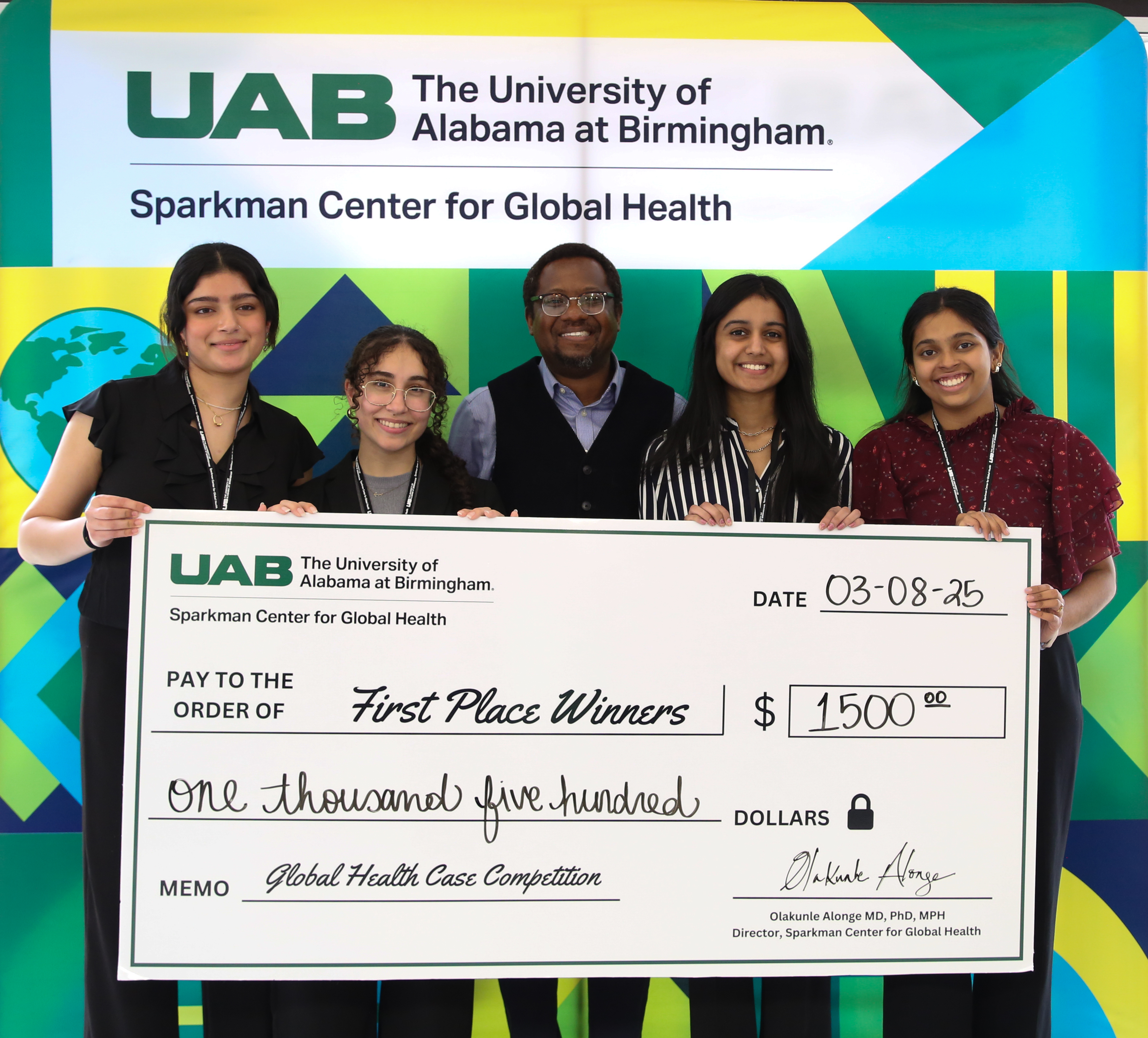 UAB students and Dr. Alonge in group with winning check looking at the camera