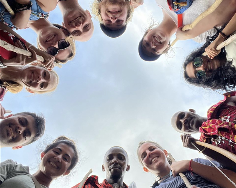 UAB students in a circle looking down at the camera