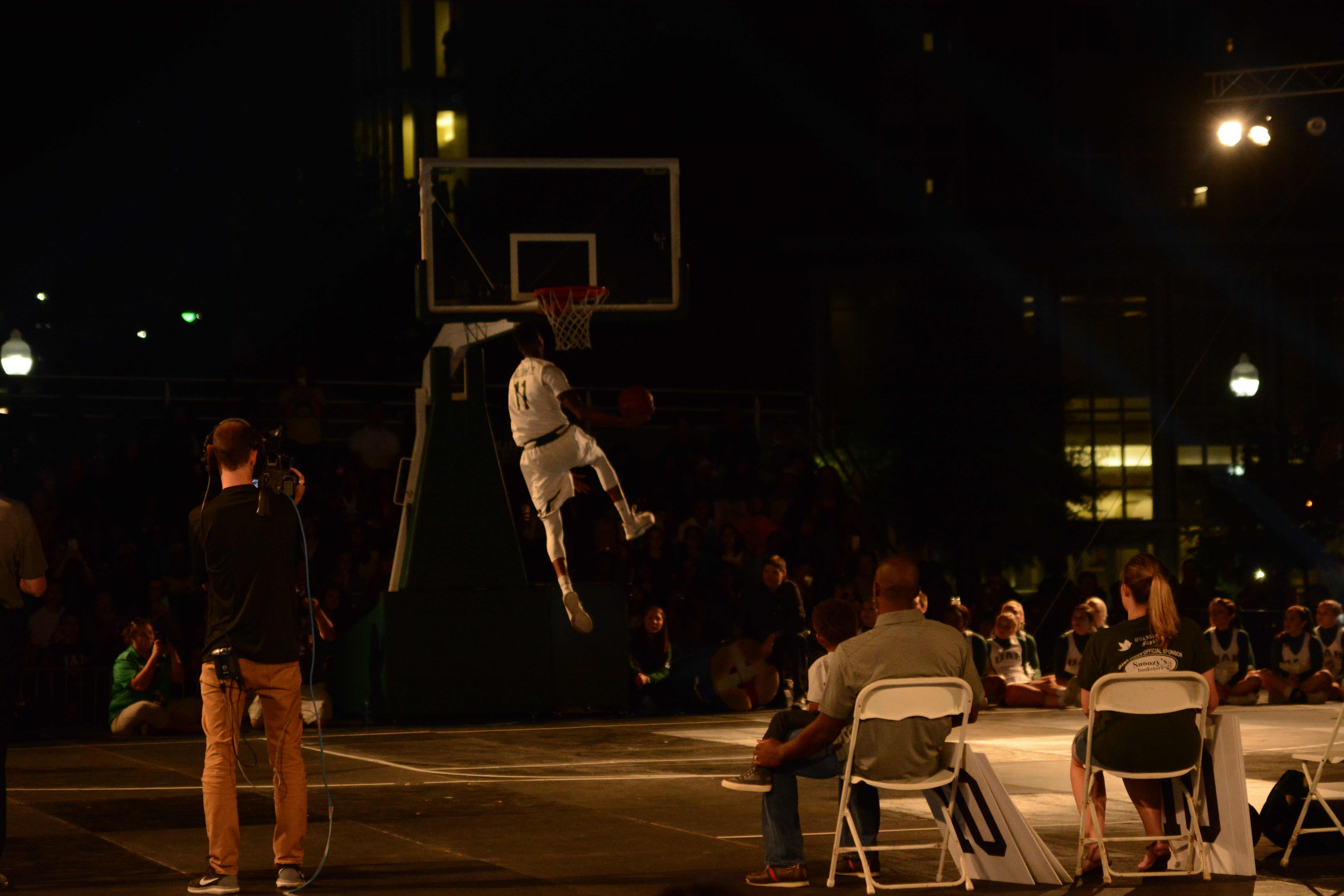 Senior guard Dirk Williams dunks the ball during the dunking contest at Hoops on the Green. Photo by Giani Martin