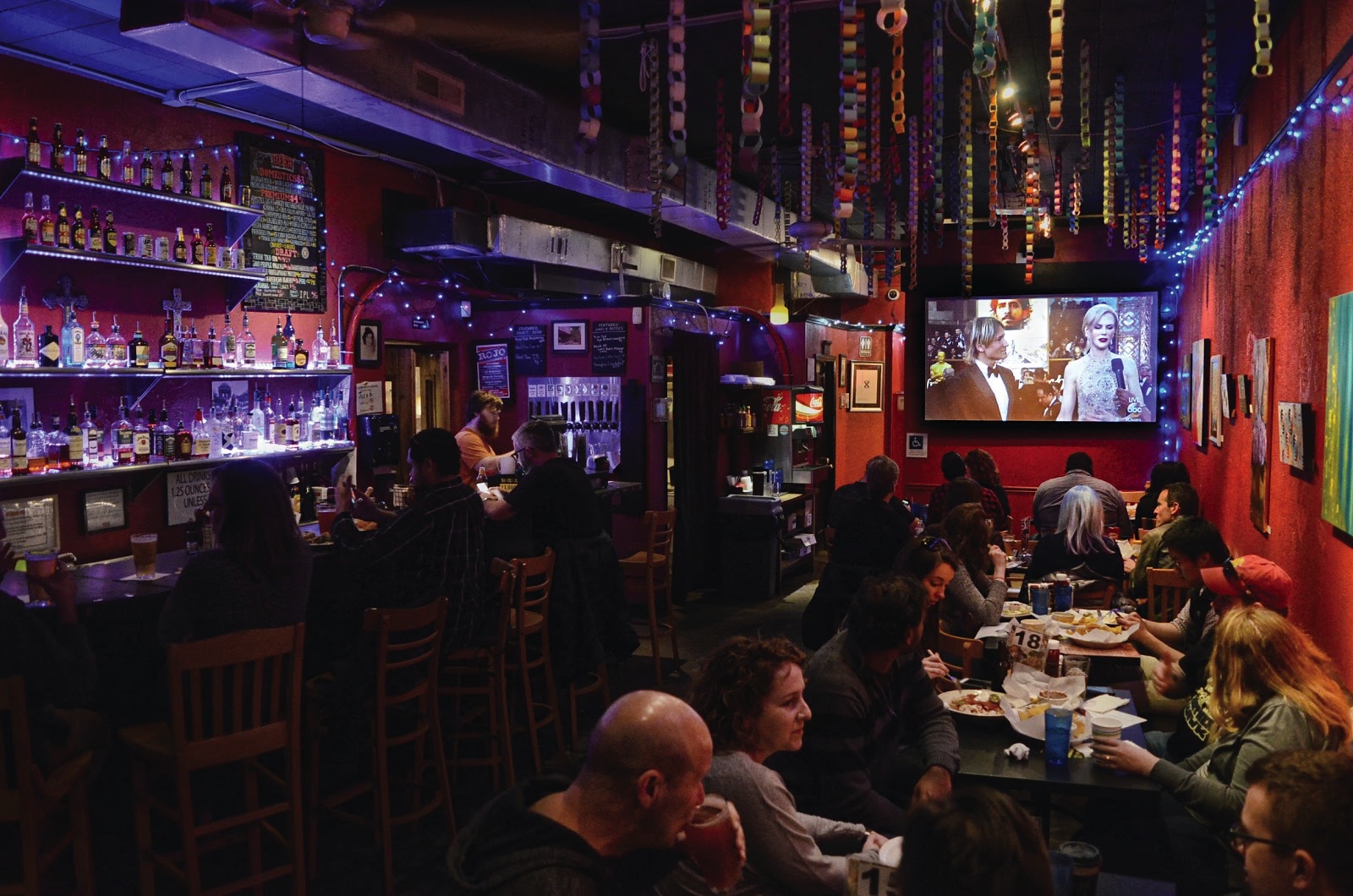 Oscar viewers sit and eat during a 89th Academy Awards viewing party at Rojo. Photo by Ian Keel/Photo Editor