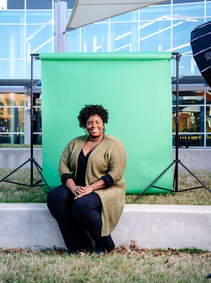 Photo of Eboni Murdock against green backdrop and photo lights