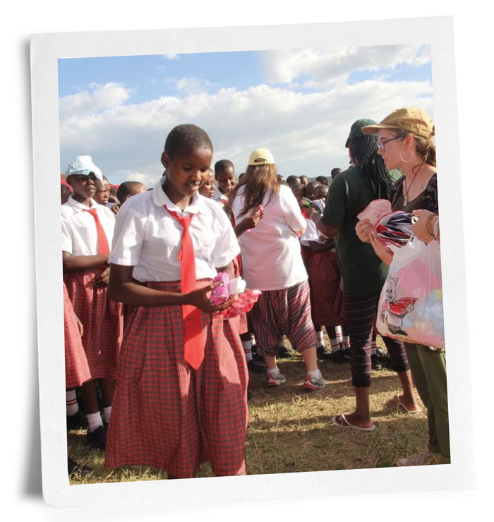 Photo of Kenyan girls receiving sanitary supplies from UAB students